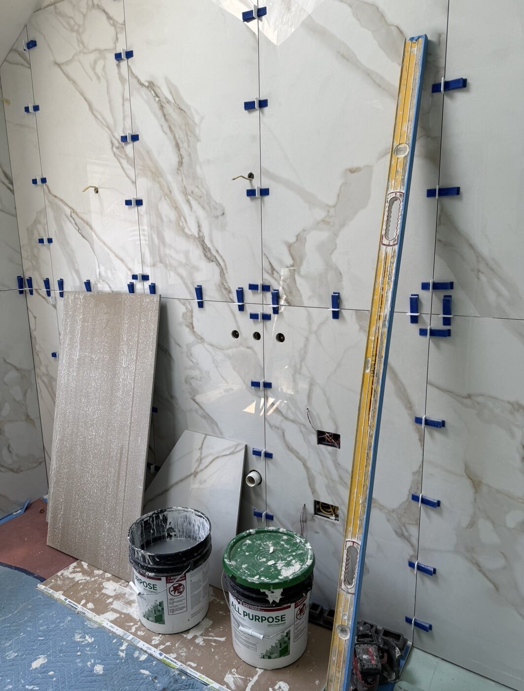 Marble-look wall tile installation in progress — Staten Island bathroom remodel