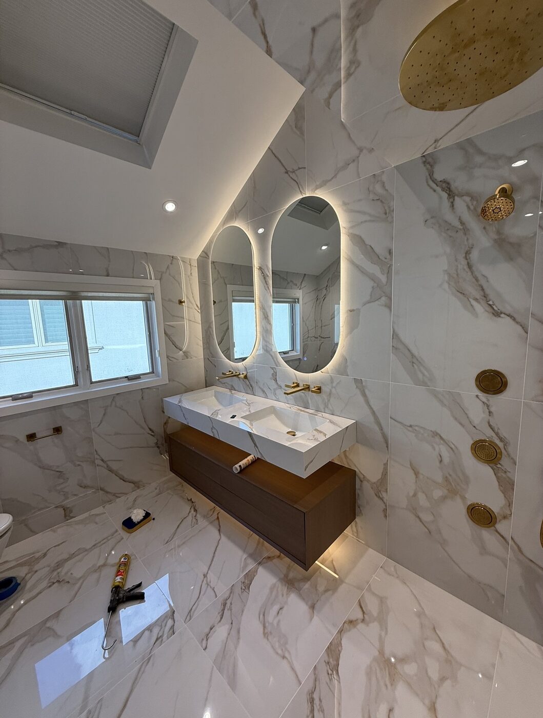 Finished bathroom remodel with floating double vanity and gold fixtures — Staten Island